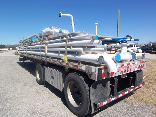 Image of delivery truck with pipes in the back