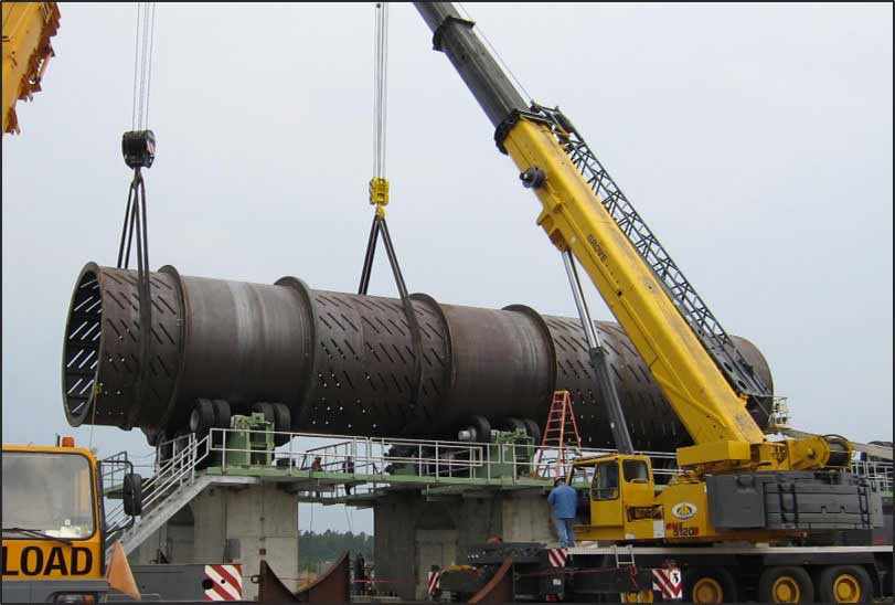 Image of Debarker being lifted by yellow crane.
